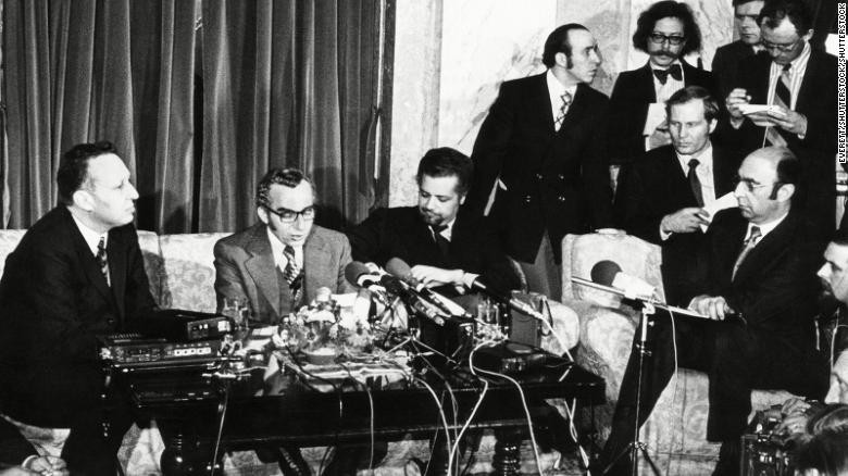 Oil ministers including Ahmed Zaki Yamani (seated, with moustache and beard) announce OPEC is lifting the oil embargo against the United States. 